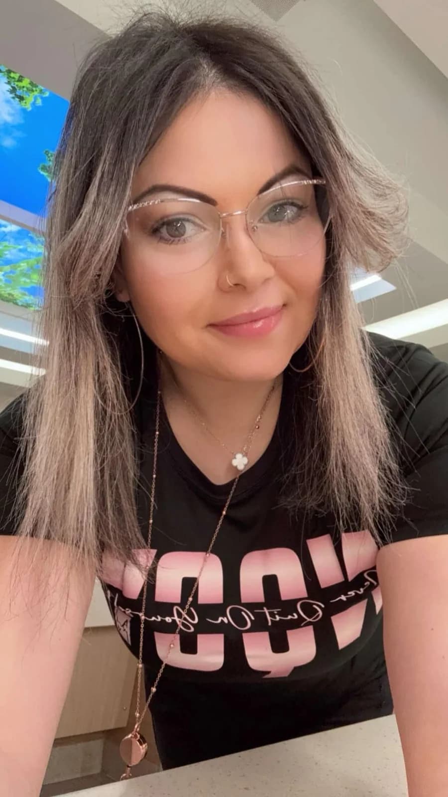A woman wearing an NQOY tee
