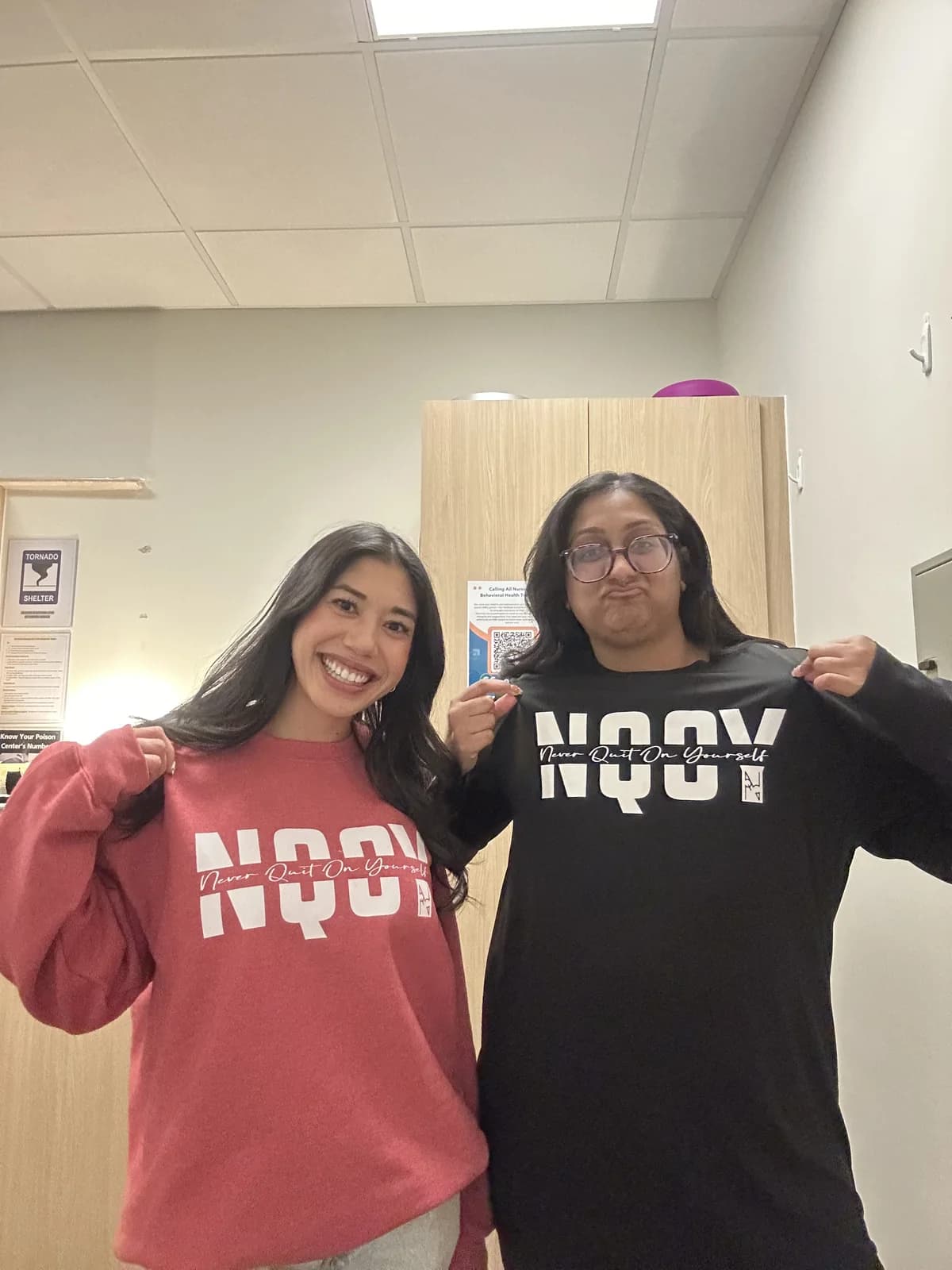 Two friends in NQOY hoodies